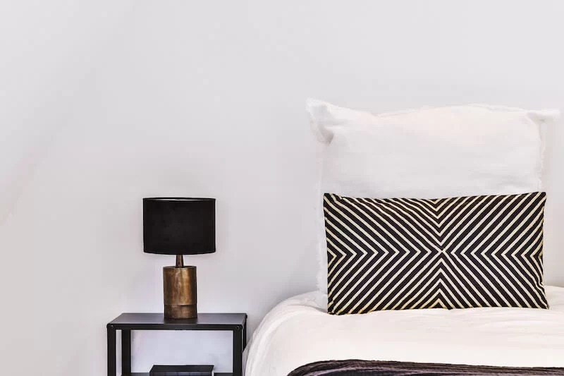 decorate the bedside table with a lamp