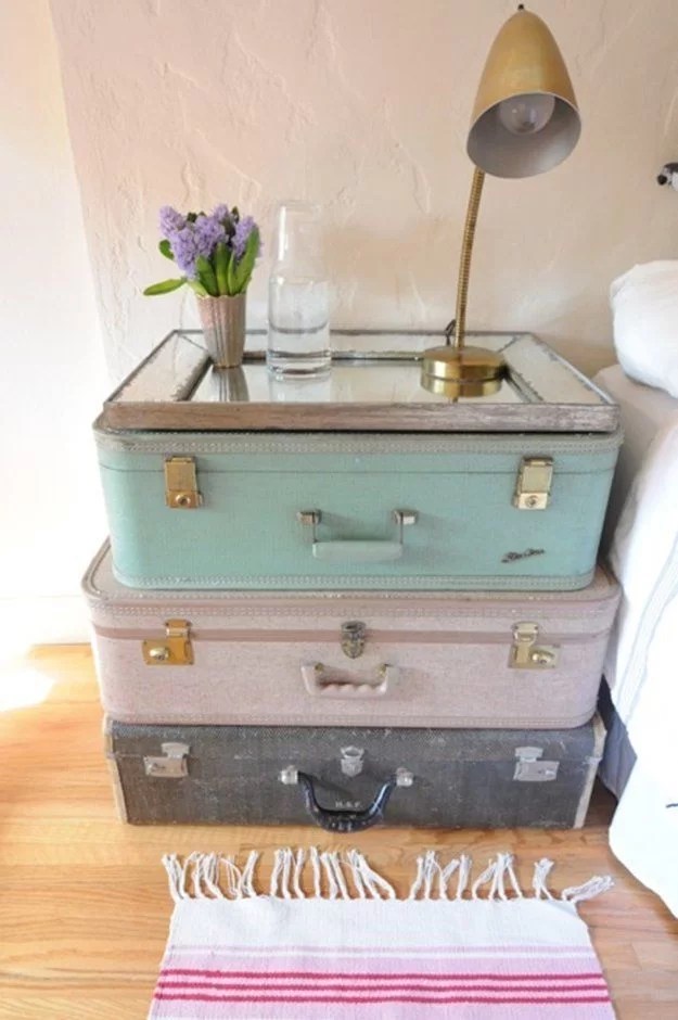 decorate with suitcases and recycle on the nightstand