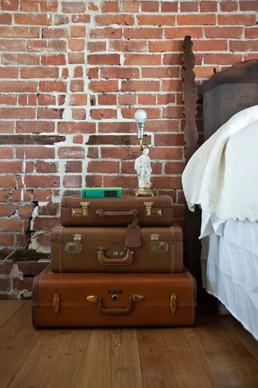 decorate with suitcases and recycle on the nightstand